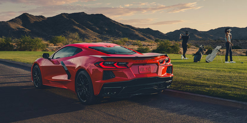 A 2026 red Corvette parked along the roadside, highlighting its sporty appearance and modern features.