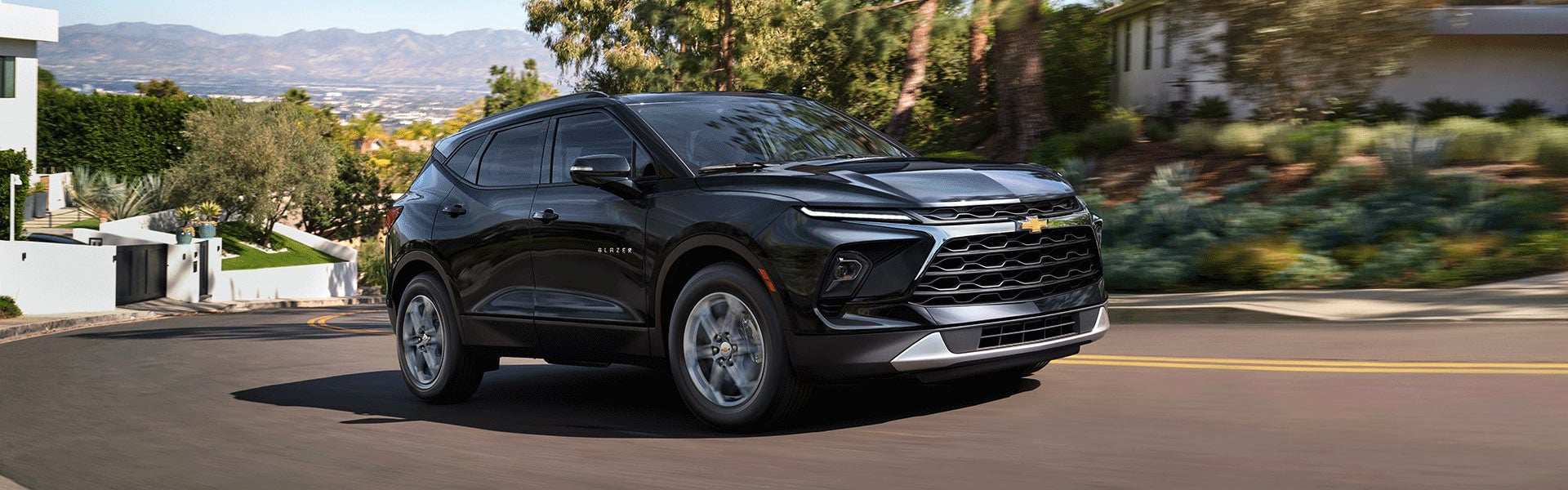 A 2026 Chevrolet Blazer driving down a city street, showcasing its sleek design and modern features.