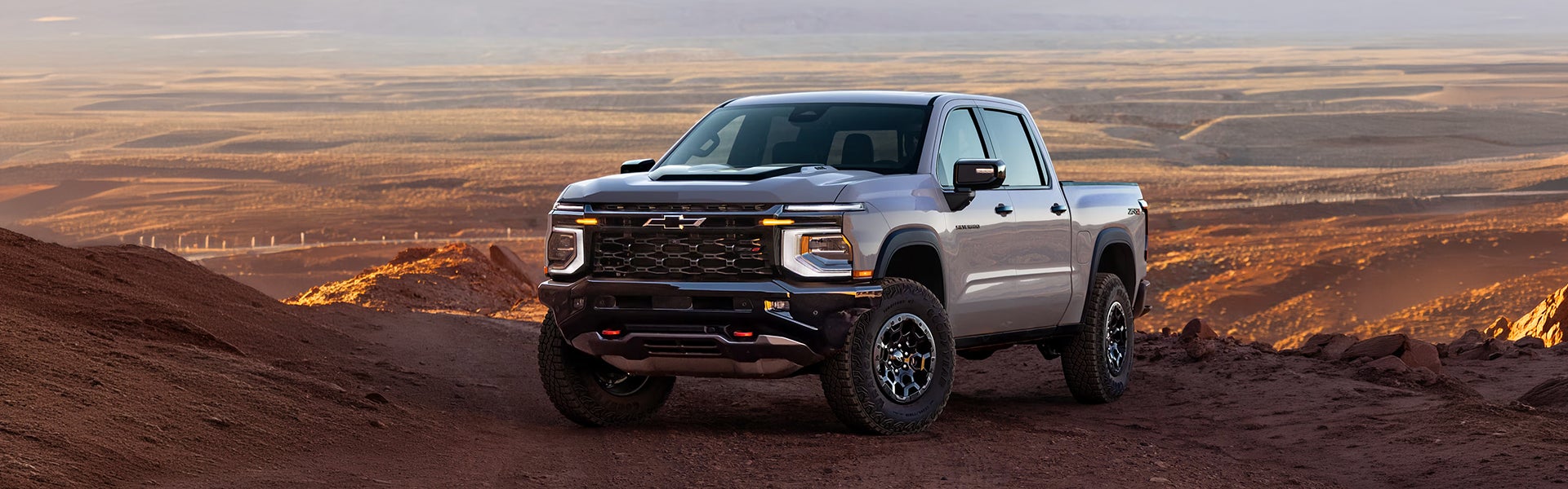 2027 Chevrolet Silverado 1500 parked on a mountain landscape.