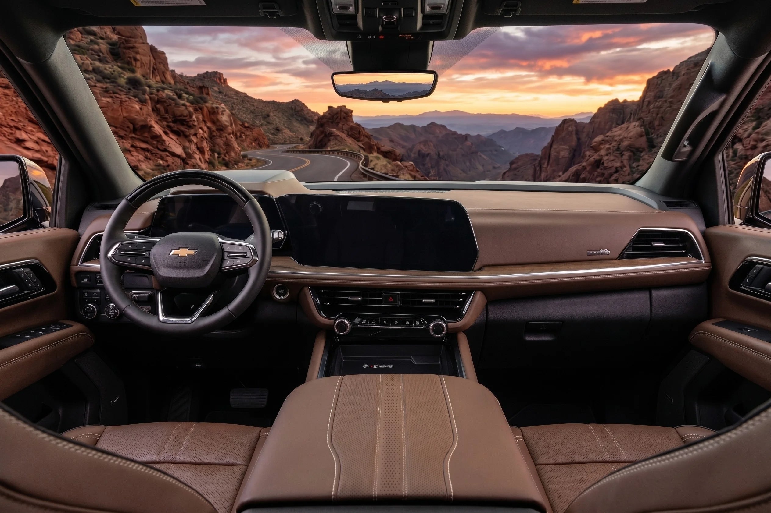A canyon sunset view from the backseat of the 2026 Chevy Tahoe