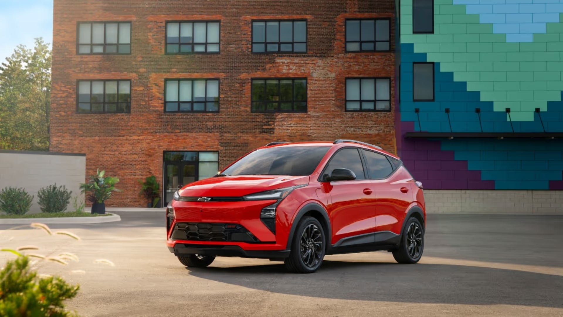 2027 Chevy Bolt parked in front of a brick building