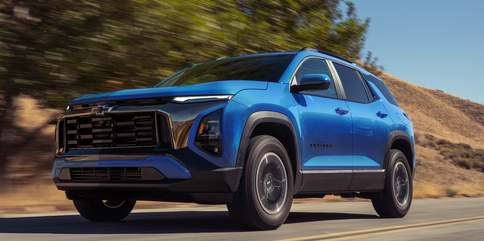 2027 Equinox driving down a desert road